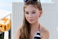 Young girl in a swimsuit on a shelf by the pool Royalty Free Stock Photo