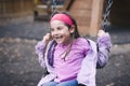 Young girl on a swing having fun