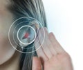 Young girl with symptom of hearing loss. Close up. Isolated on white background