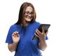 Young girl with a tablet laughs. Pretty brunette in a blue T-shirt. Online communication, training and social networks. Isolated Royalty Free Stock Photo