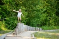 Young girl on tactile path in barefoot park created to feel the ground and other materials with bare feet. Strengthen foot and leg