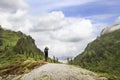 Young girl take picrure on the top of the mountain