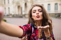 Young girl take selfie from hands with phone on summer city street urban life concept Royalty Free Stock Photo