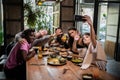 Young girl taking a photo with her friends in a cafe Royalty Free Stock Photo