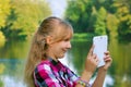 Young girl taking photo of the lake by tablet pc Royalty Free Stock Photo