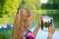 Young girl taking photo of the lake by tablet pc Royalty Free Stock Photo