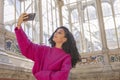 young girl taking a picture with her phone while waiting for her boyfriend Royalty Free Stock Photo