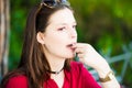 Young girl is taking a pill in the park Royalty Free Stock Photo