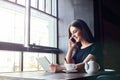 Young girl talking on mobile phone in coffee shop Royalty Free Stock Photo