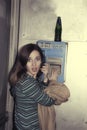 Young girl talking in public pay telephone Royalty Free Stock Photo