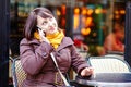 Young girl talking on thephone in Parisian cafe Royalty Free Stock Photo