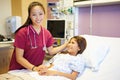 Young Girl Talking To Female Nurse In Hospital Room Royalty Free Stock Photo