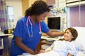 Young Girl Talking To Female Nurse In Hospital Room Royalty Free Stock Photo