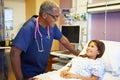 Young Girl Talking To Male Nurse In Hospital Room Royalty Free Stock Photo