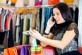 Young girl talking via phone in store Royalty Free Stock Photo