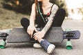 Young girl with tattoo and dreadlocks sitting in the park Royalty Free Stock Photo