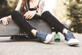 Young girl with tattoo and dreadlocks sitting in the park Royalty Free Stock Photo