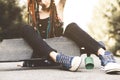 Young girl with tattoo and dreadlocks sitting in the park Royalty Free Stock Photo