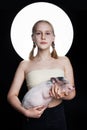 Young girl teen holding mini pig, creative portrait. Environmental protection concept Royalty Free Stock Photo