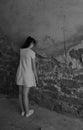 Young girl teenager with depression stands leaning against an old brick wall, vertical frame, copy space Royalty Free Stock Photo