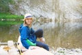 Young girl teen smiling sitting on a boat in gloves for rowing. Teenage summer vacations, youthful outdoor activities Royalty Free Stock Photo