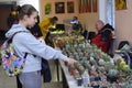 Young girl teeneger buying potted cactus at the flower shop Royalty Free Stock Photo