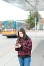 Young girl texting on bus stop