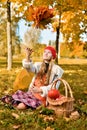 Young girl throws a bouquet of autumn leaves