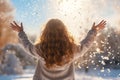 Young girl throws snow on a sunny winter day in the park