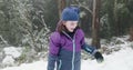 Young girl throws a snowball then claps with delight