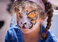 Young Girl with Tiger Face Painting. Royalty Free Stock Photo