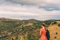 Young girl tourist admiring landscape of Cap de Creus