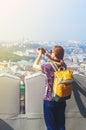 Young Girl Tourist Takes Pictures of Sights