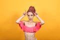 Young girl with towel on her head over isolated orange background shows emotions Royalty Free Stock Photo