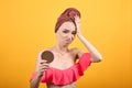 Young girl with towel on her head over isolated orange background shows emotions Royalty Free Stock Photo