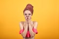 Young girl with towel on her head over isolated orange background shows emotions Royalty Free Stock Photo