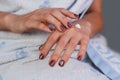 Young girl in towel putting cream on hands. Royalty Free Stock Photo