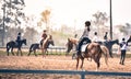 Young girl is training to ride a horse horse is in the practice field