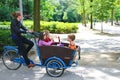 Young girl transporting children in the cart .