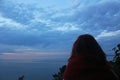 Young girl traveler looking in horizon, Black sea at sunset Royalty Free Stock Photo