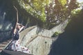 Young girl traveler sitting on circle stairs of a spiral staircase of an underground crossing in tunnel at Fort Canning Park, Sin Royalty Free Stock Photo