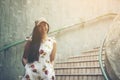 Young girl traveler sitting on circle stairs of a spiral staircase of an underground crossing in tunnel at Fort Canning Park, Sin Royalty Free Stock Photo