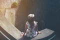 Young girl traveler sitting on circle stairs of a spiral staircase of an underground crossing in tunnel at Fort Canning Park, Sin Royalty Free Stock Photo