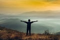 Young girl traveler stands on a cliff in the summer mountains at sunrise and enjoys a view of nature