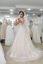 Young girl is trying on beautiful wedding gown in shop Royalty Free Stock Photo