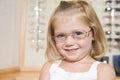 Young girl trying on eyeglasses at optometrists Royalty Free Stock Photo