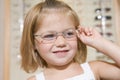 Young girl trying on eyeglasses at optometrists Royalty Free Stock Photo