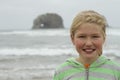 Young girl by twin rocks on Rockaway beach Oregon Royalty Free Stock Photo