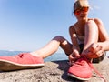 Young girl tying shoelace. Royalty Free Stock Photo