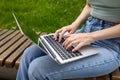 A young girl types on the keyboard of a laptop, computer.